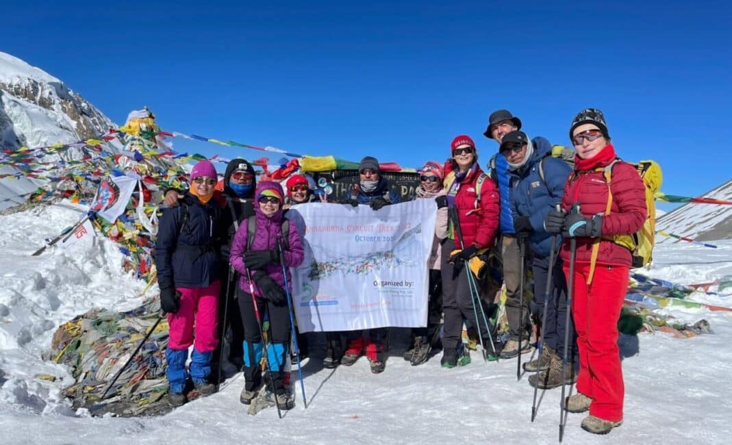 The trekkers are taking a group photo at Thorong La (5416m), the highest height of the Annapurna Circuit trek.
