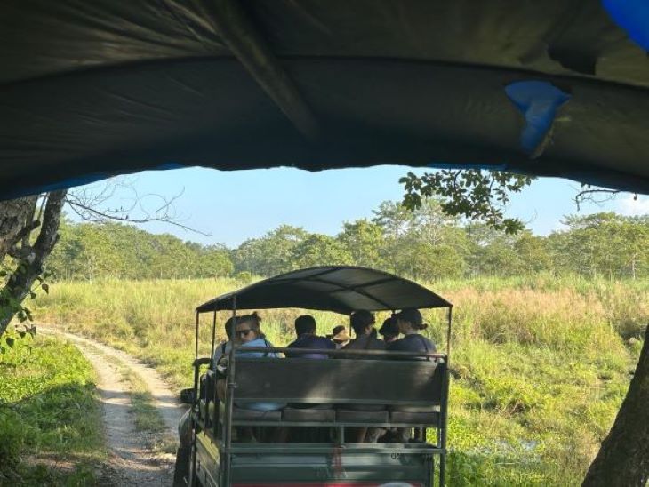 View of a jeep filled with tourists on a safari trail in Chitwan National Park.
