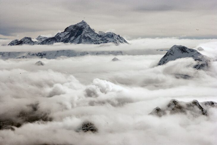 Stunning aerial perspective of Mount Everest towering above the clouds.